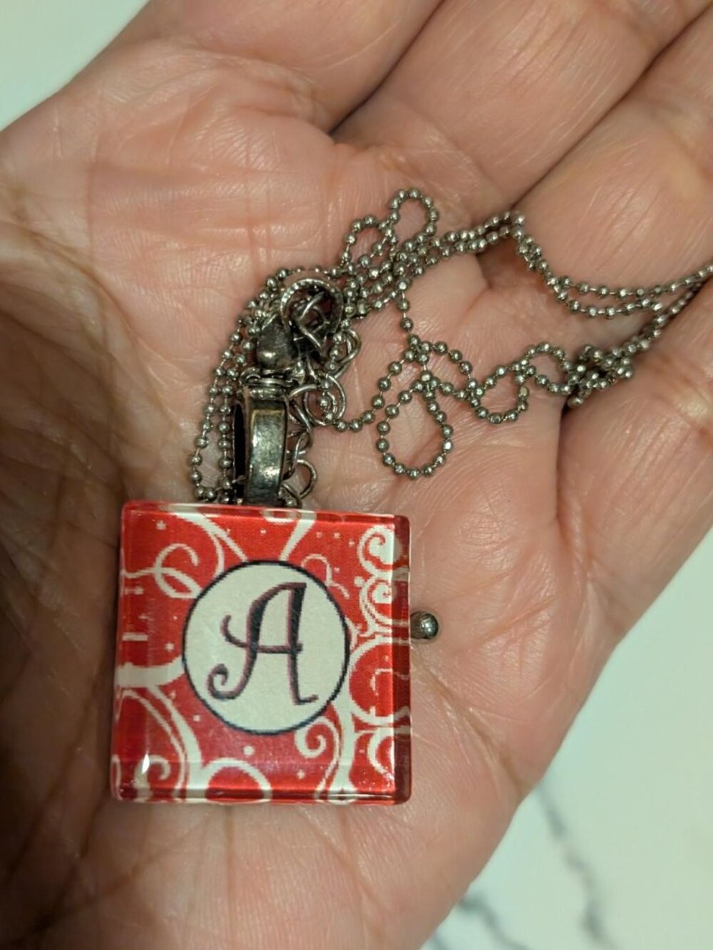 Cute Resin Letter "A" Pendant Necklace with a Red & White background